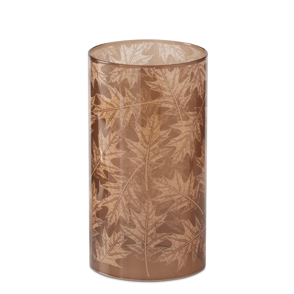 Brown glass cylindrical candle slip cover featuring an etched oak leaf pattern on a translucent amber background.