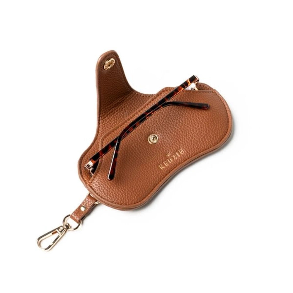 Open Kedzie brown pebbled leather eyewear case with tortoise shell glasses inside and a gold clip attachment.