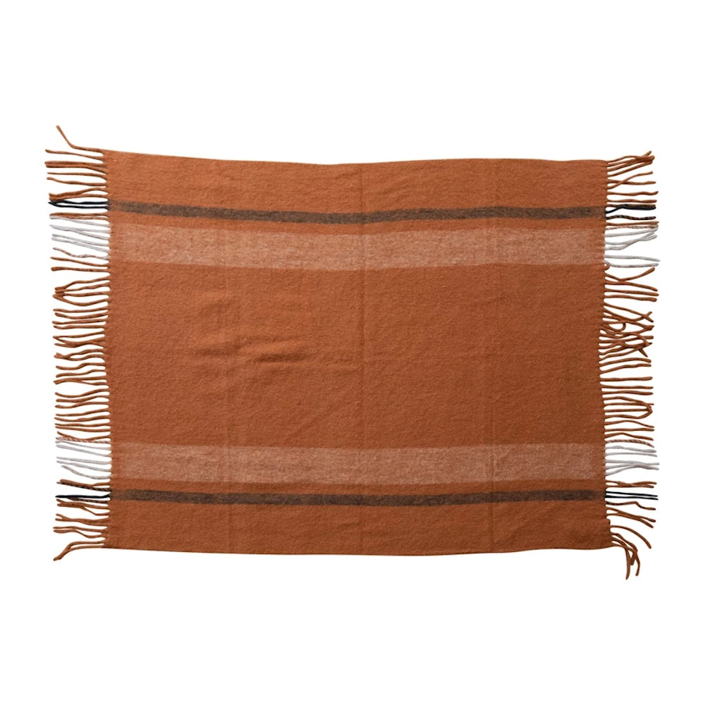 Brushed New Zealand wool and acrylic striped throw blanket in rust orange with fringed edges.