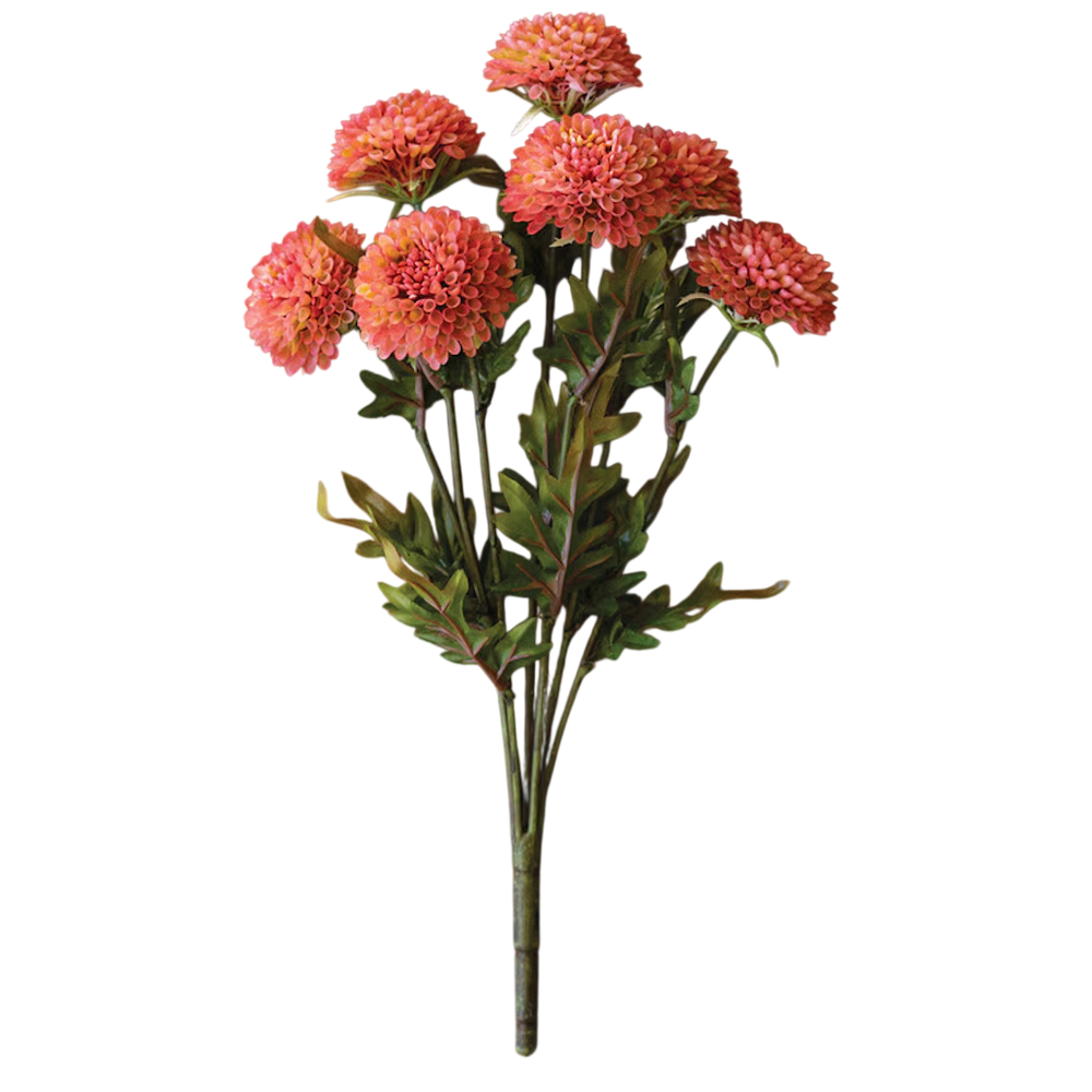 A bunch of artificial blush pink ball dahlia flowers with green leaves on a single stem on white background.