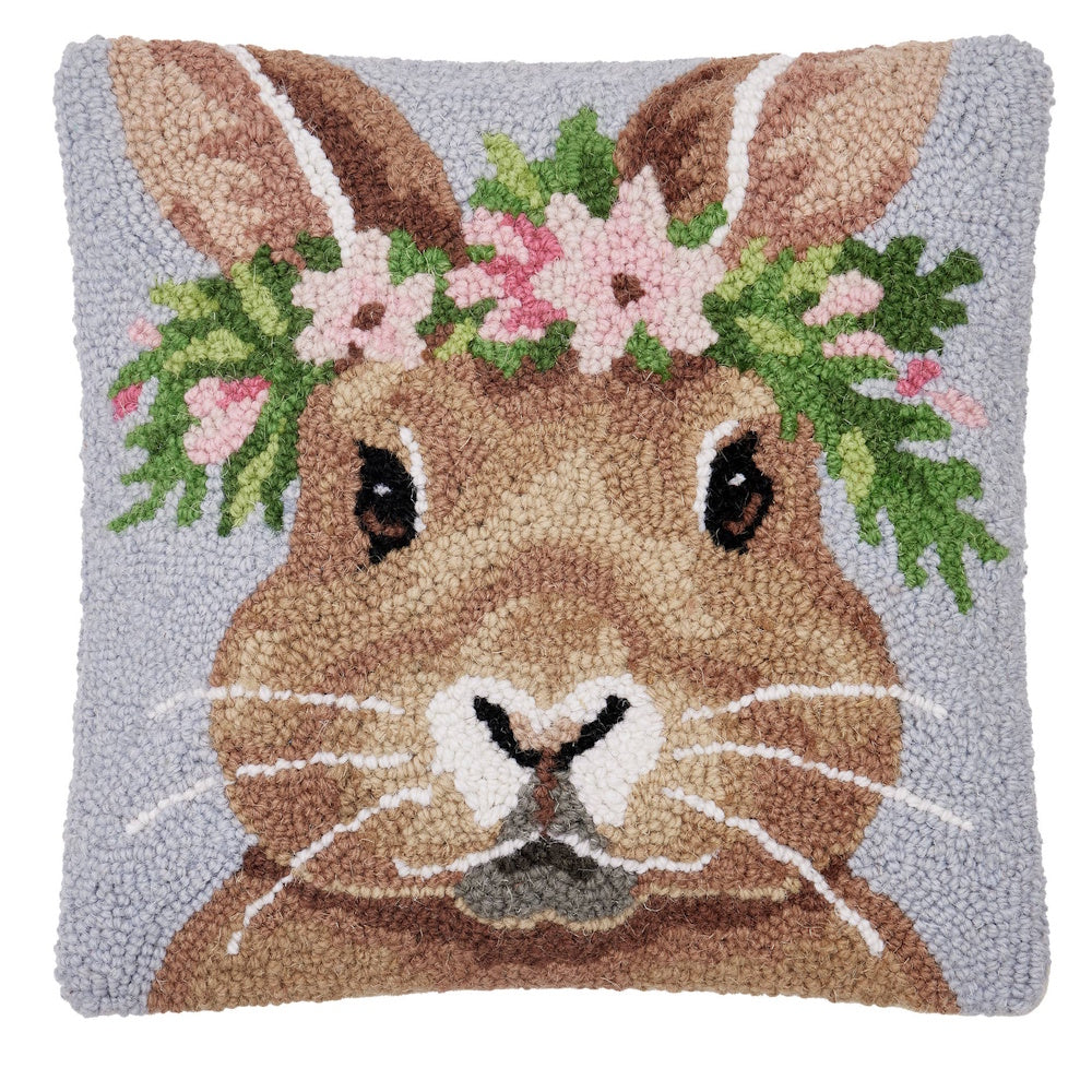 Hand-hooked decorative pillow featuring a brown bunny wearing a pink floral crown against a light blue background.
