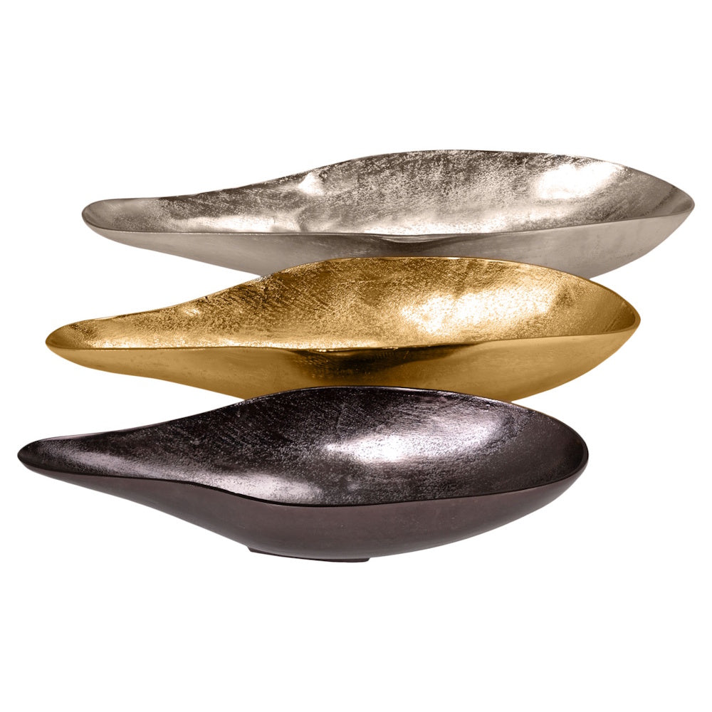 Three metallic decorative leaf-shaped trays in silver, gold, and bronze finishes stacked against a white background.