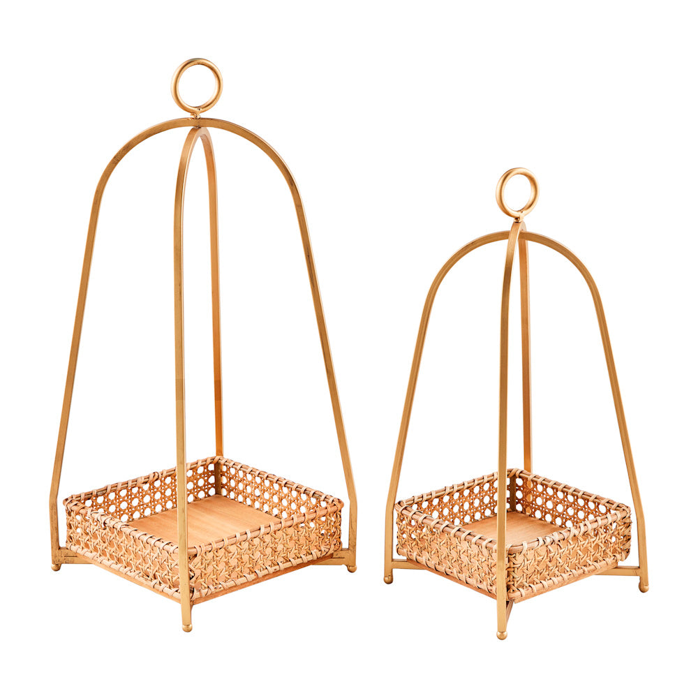 Set of two gold metal lanterns with woven cane tray bases and arched frames, ideal for boho home decor.