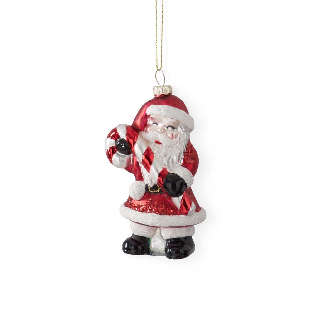 A hanging vintage glass Santa ornament holding a candy cane.