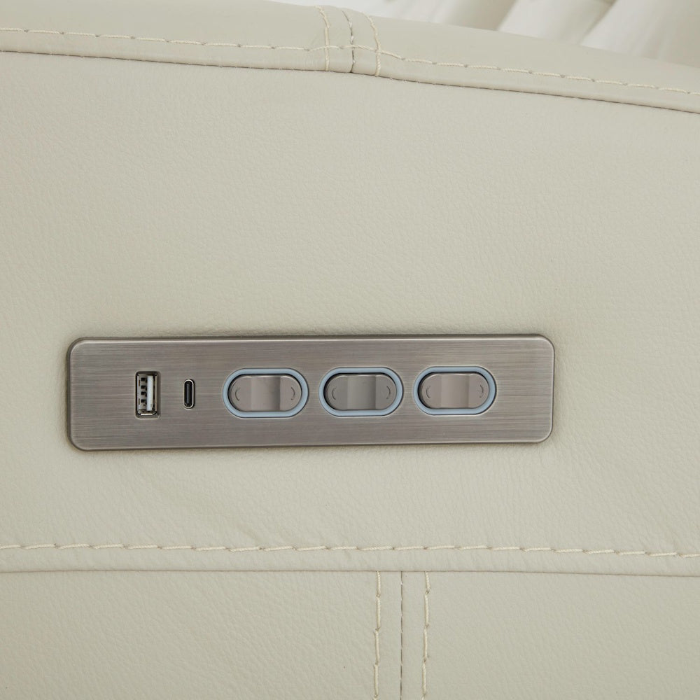 Close up of power recliner control panel with USB ports and adjustable seat position buttons on leather sofa.