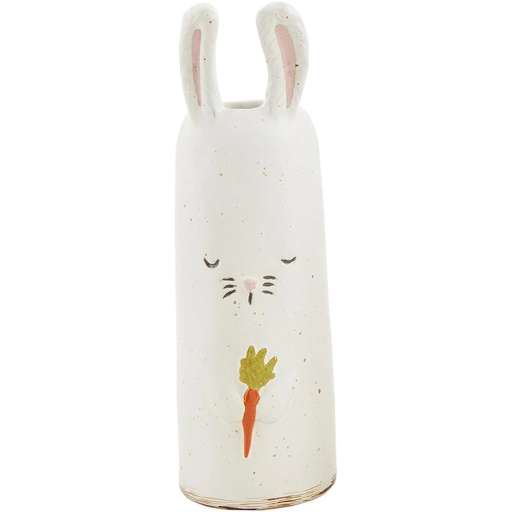 A tall, white ceramic bunny vase with long ears, closed eyes, and holding a small orange carrot.
