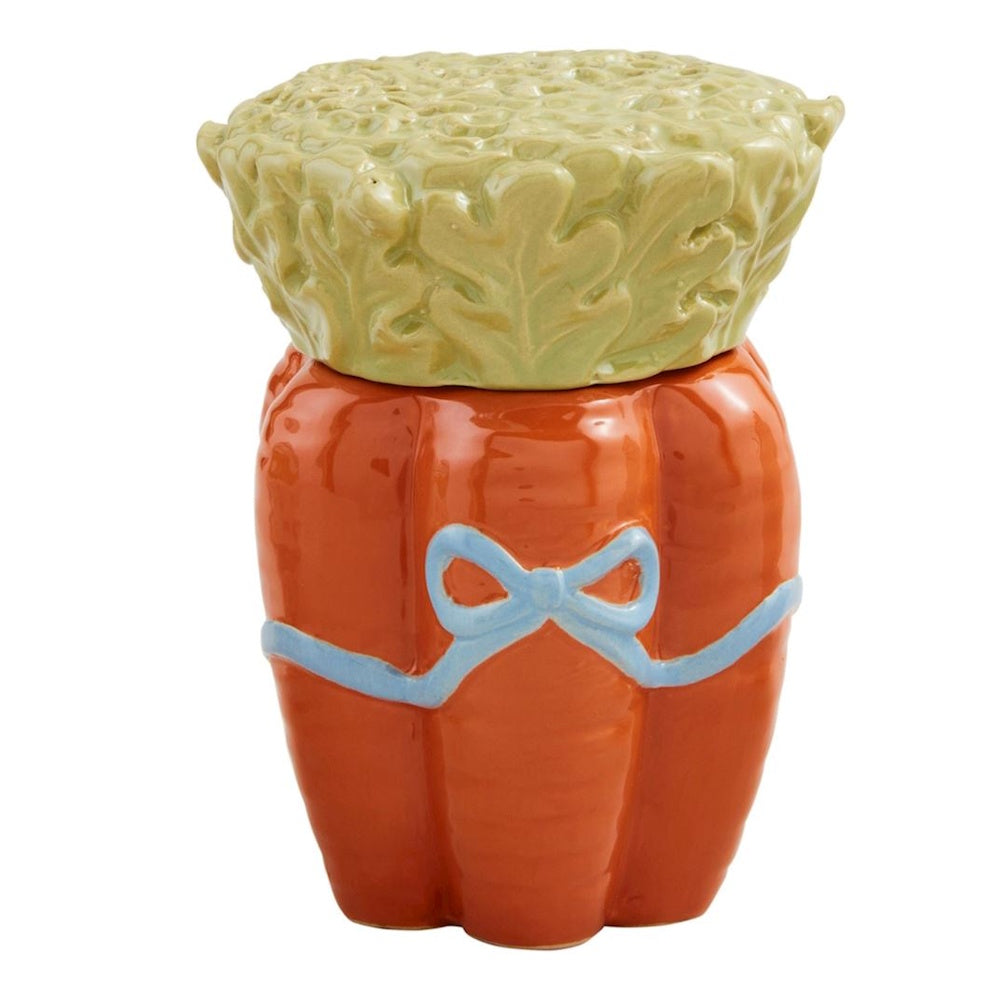 Ceramic carrot-shaped jar with a green leafy lid and a light blue painted bow wrapped around the middle.