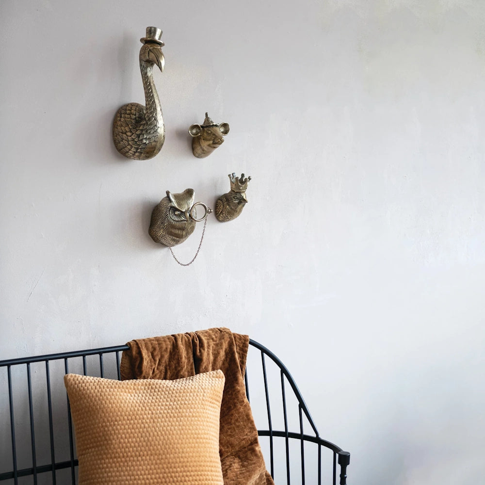 Antique animal head wall decor collection including a flamingo in a top hat and a bird with a crown.