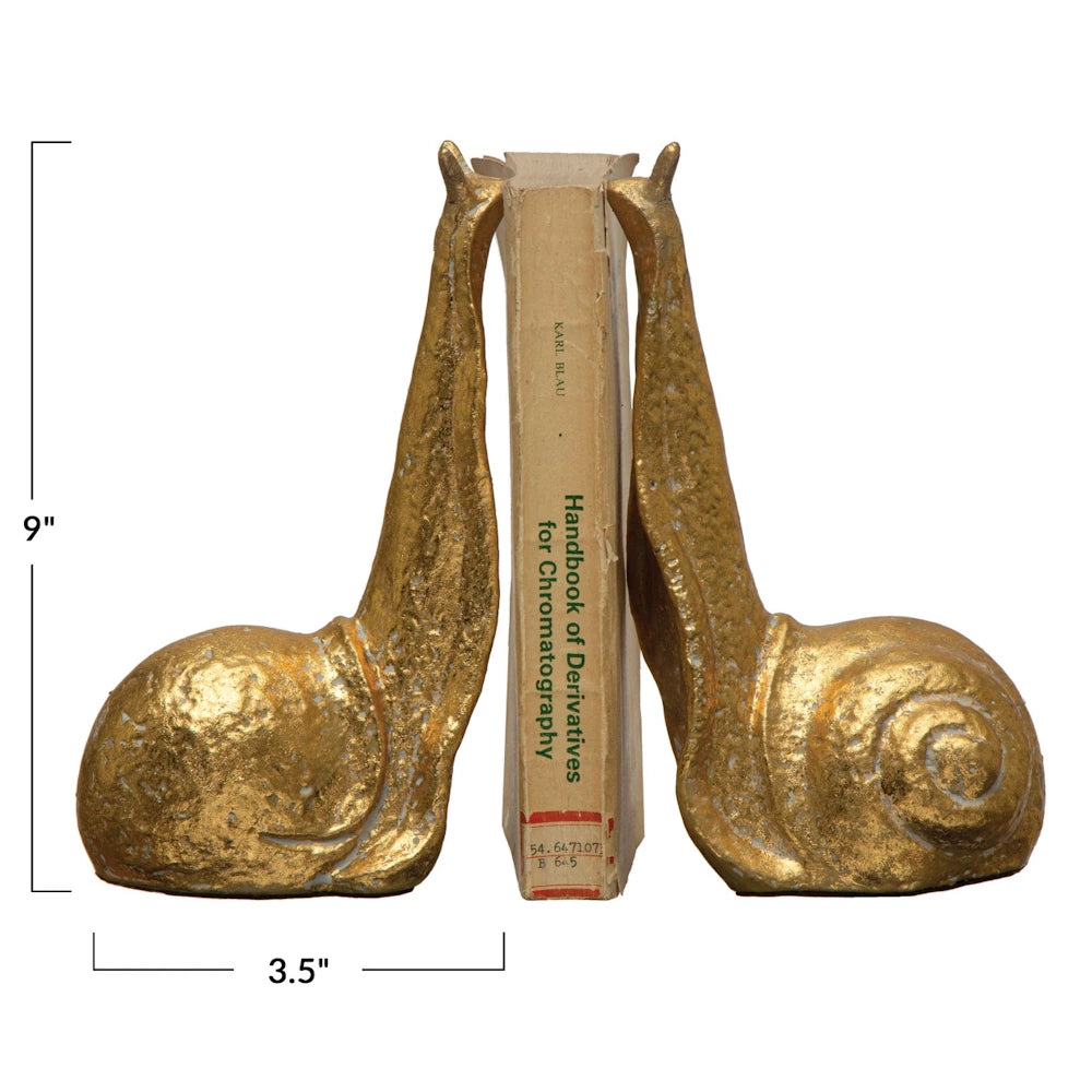 Gold snail bookends holding a book. Dimensions: 9 inches tall and 3.5 inches wide.