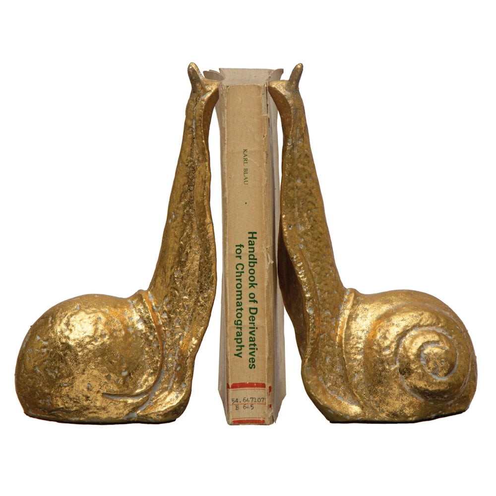 Gold snail bookends holding Karl Blau's Handbook of Derivatives for Chromatography book.