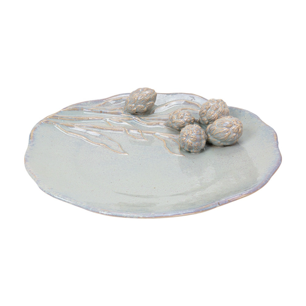 Pale blue ceramic Cazaria platter with embossed artichokes and stems, featuring an irregular, organic rim.