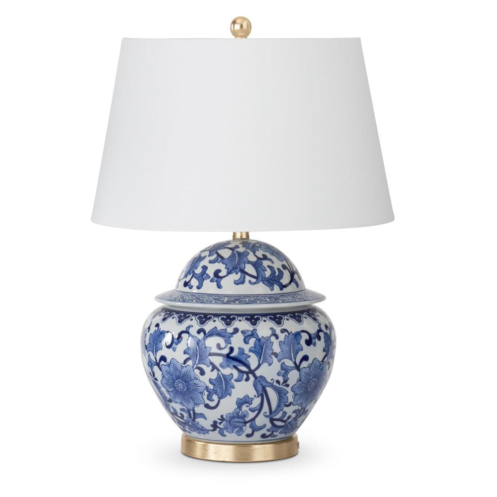 Blue and white ceramic ginger jar table lamp with a floral pattern, white drum shade, and gold base and finial.
