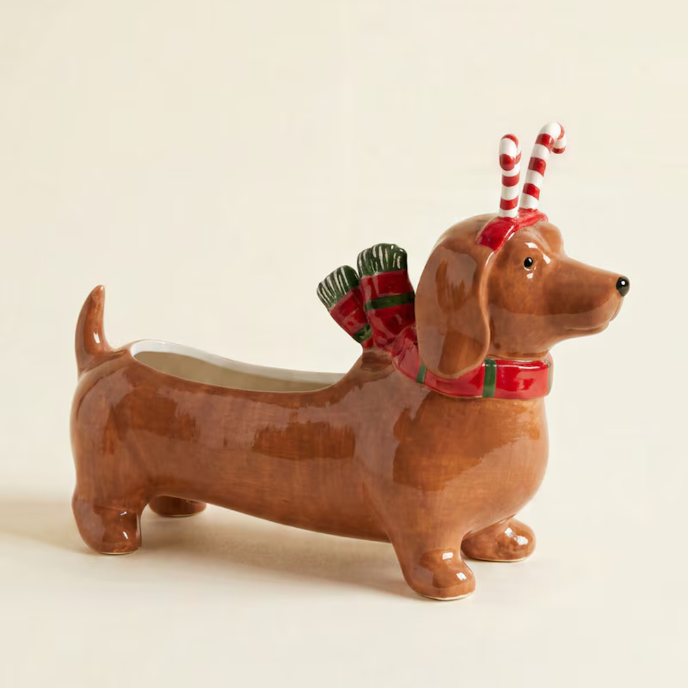 Brown ceramic dachshund planter wearing a red holiday scarf and candy cane headband.