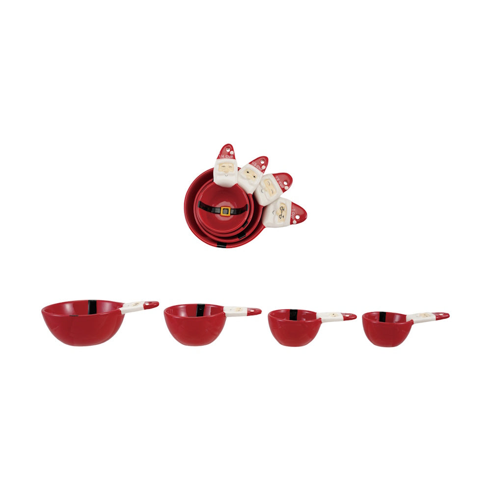 A set of nested red ceramic measuring cups shaped and painted to look like Santa Claus.