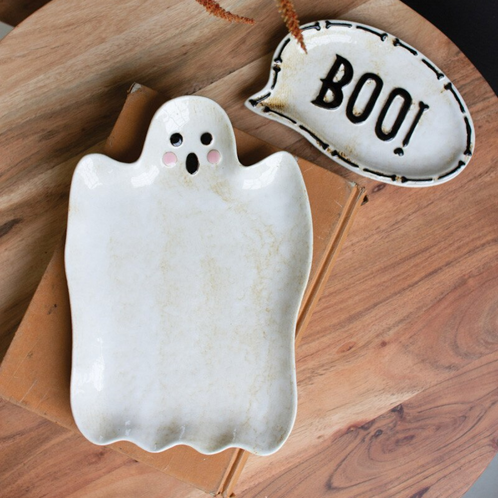 Ceramic ghost platter and Boo speech bubble dish on a wooden table.