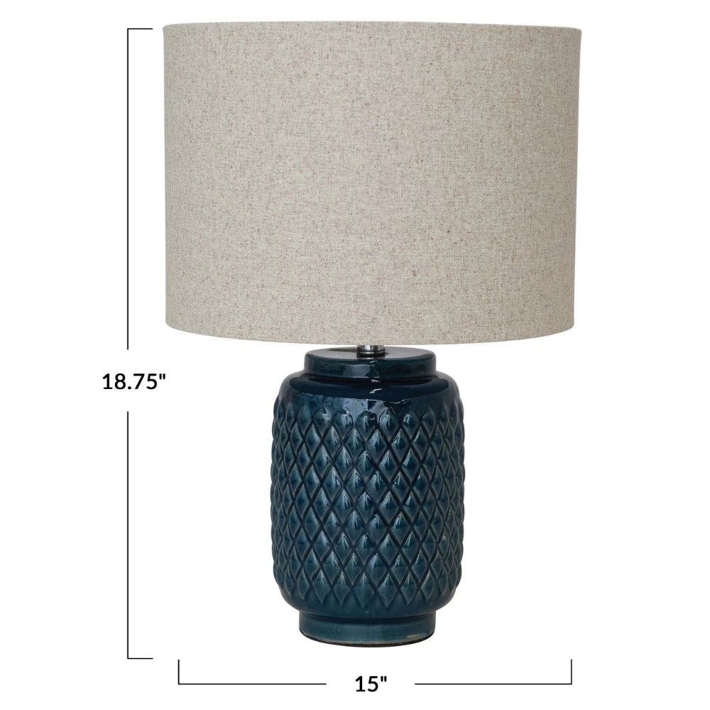 18.75-inch blue ceramic table lamp with diamond texture and tan linen drum shade, 15 inches wide.