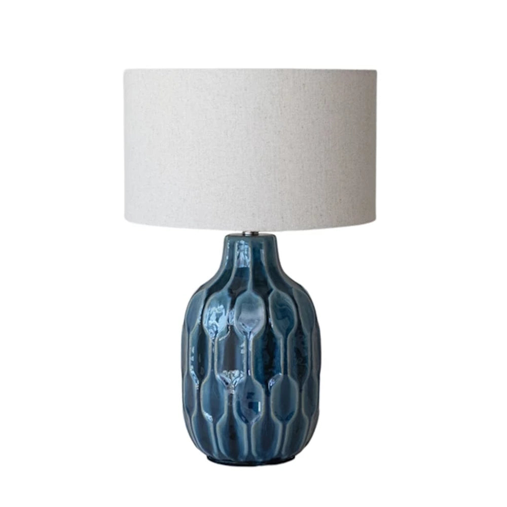 Blue ceramic table lamp with a patterned base and a light grey fabric shade.