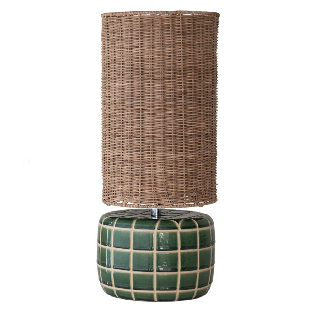 Ceramic tiled table lamp with a dark green base and a tall hand-woven rattan drum shade on a white background.