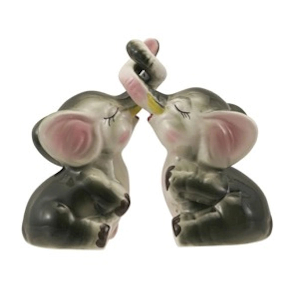 Vintage-style ceramic elephant salt and pepper shakers with interlocking trunks and pink accents on a white background.