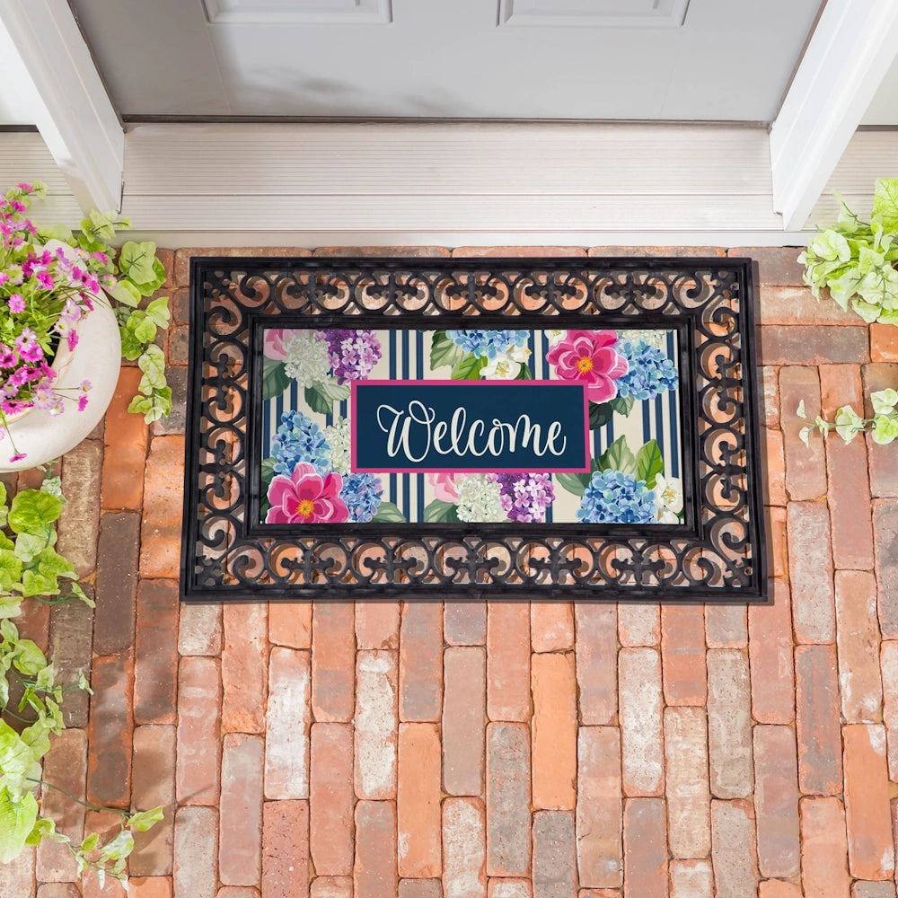 Chinoiserie floral Welcome mat with pink and blue flowers on a striped background, framed by a black scrollwork border.