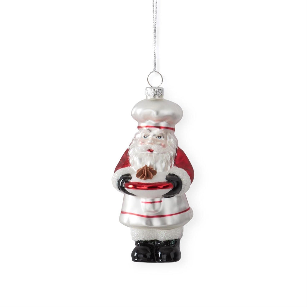 A hanging Chef Santa blown glass ornament holding a chocolate treat.