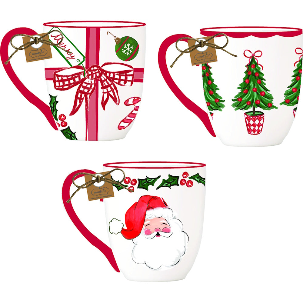 Three ceramic hand-painted holiday mugs with gift tags attached to red handles by twine.