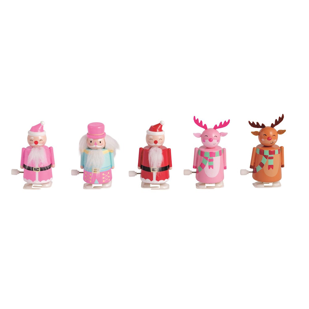 Set of five holiday wind-up toys including Santas, a nutcracker, and reindeer in pink and red.