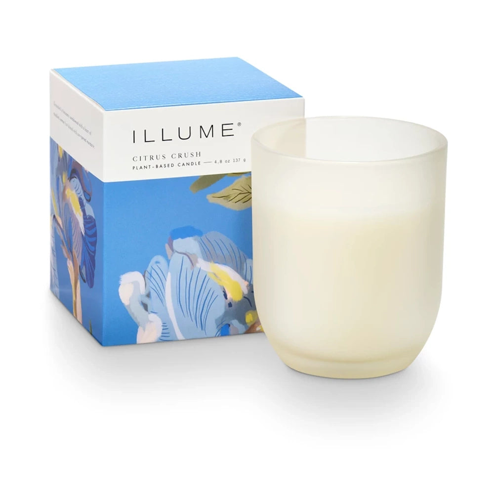 Illume Citrus Crush plant-based candle in a frosted glass jar with its blue floral decorative box.