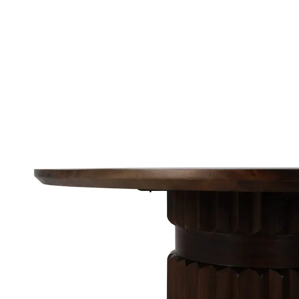 Side view of Colorado round dark wood dining table with a fluted pedestal base.