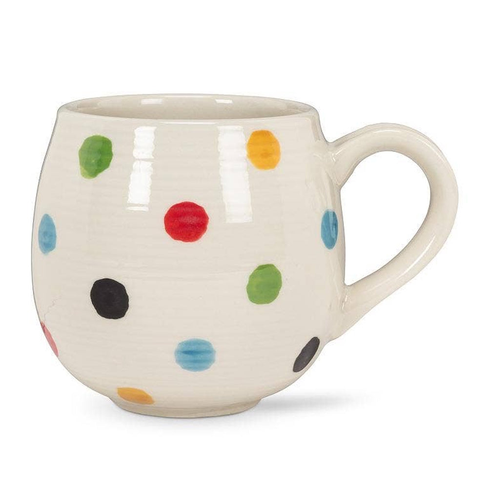 White ceramic mug decorated with colorful polka dots, isolated on white.