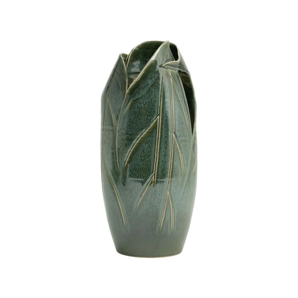 A green ceramic vase shaped like overlapping organic leaves with a glossy glaze and a textured finish.