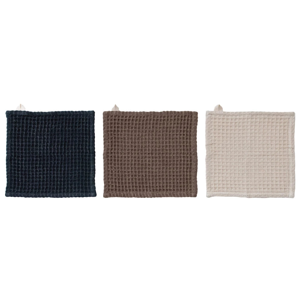 Set of three waffle-weave cotton dish cloths in charcoal, brown, and cream with hanging loops on white background.