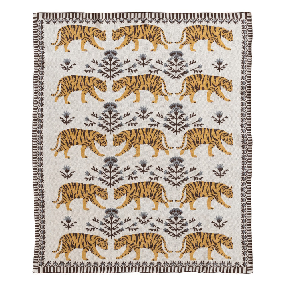 Woven tiger pattern throw blanket with floral motifs and a decorative border on a cream background.