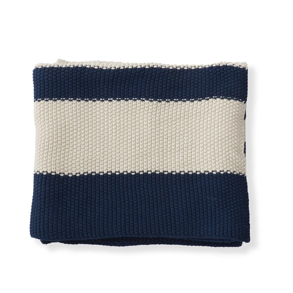 Folded navy blue and cream striped knit throw blanket with thick textured garter stitch.