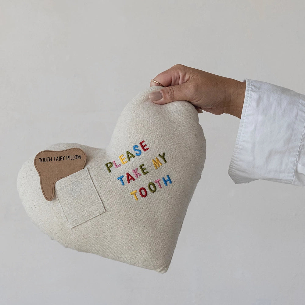 Heart-shaped linen tooth fairy pillow with a pocket and embroidered "Please Take My Tooth" in colorful letters.