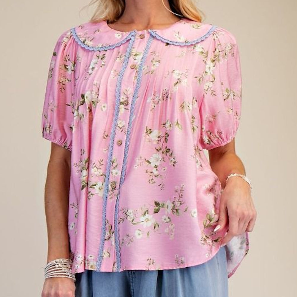 Pink floral short-sleeve cotton top with a blue lace Peter Pan collar, button-down front, and puffy sleeves.