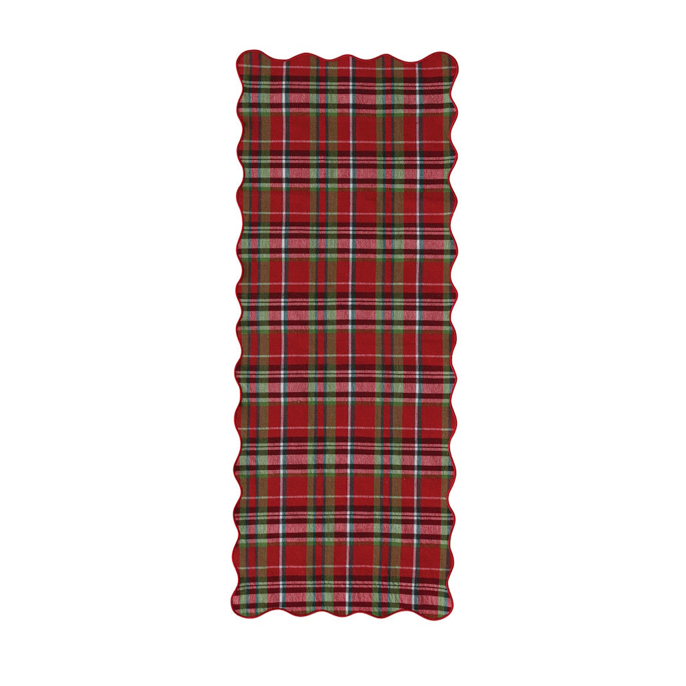 Cotton table runner featuring a red, green, and white tartan plaid pattern with a scalloped edge.