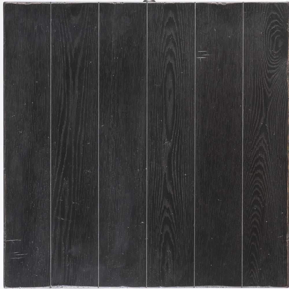 Black wood surface with visible grain, plank style paneling, and lightly distressed finish, viewed from above.