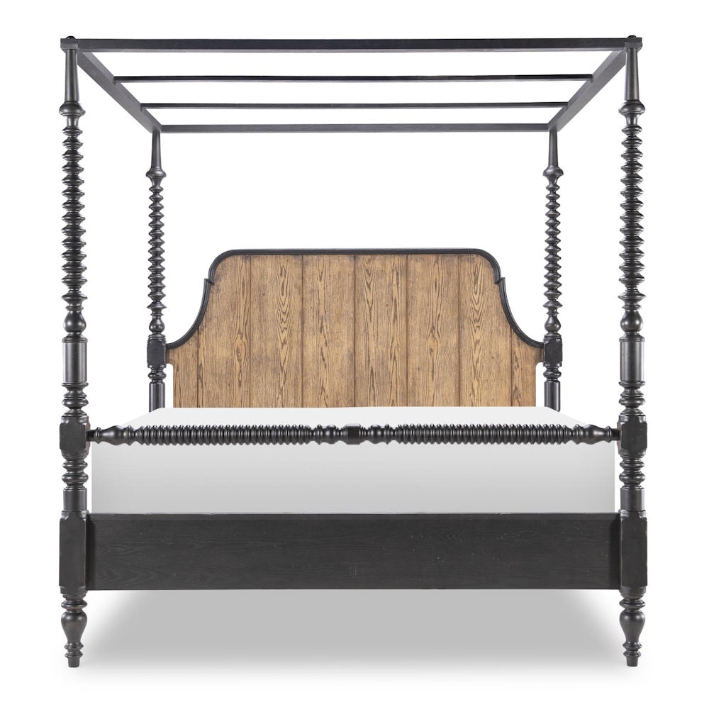 Front view of a black bobbin post canopy bed with a wood grain headboard and decorative turned details.
