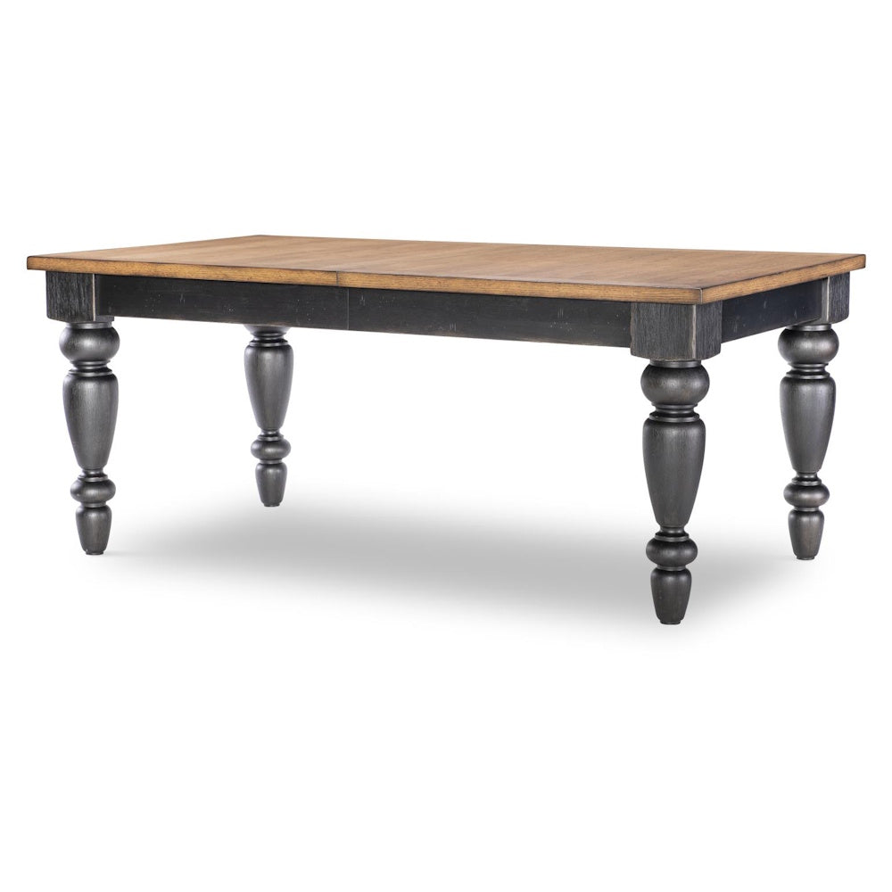 Rectangular dining table with natural wood top, black apron, and turned chimney-style legs.