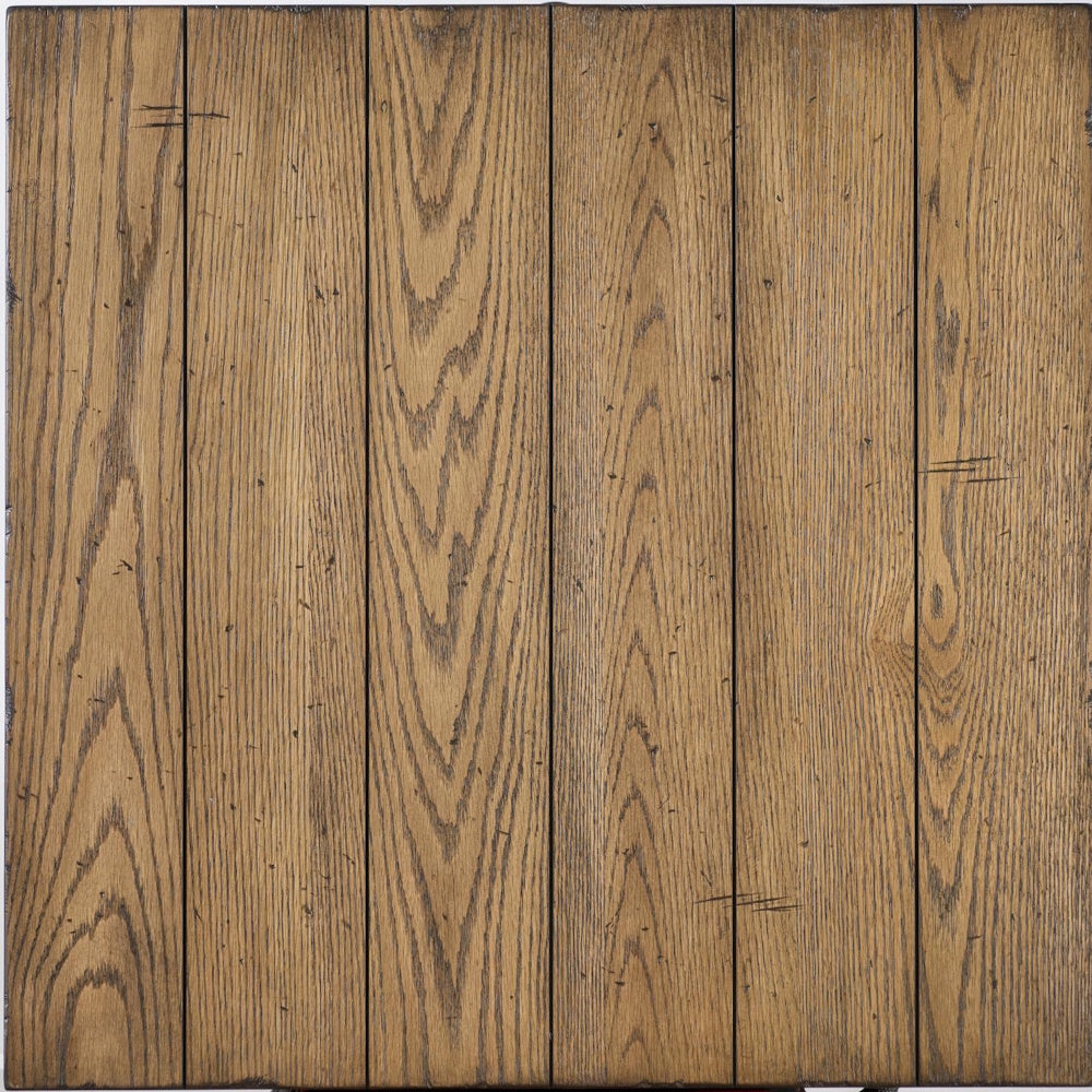 Top view of a rustic, light brown wooden tabletop featuring visible grain patterns and plank seams.