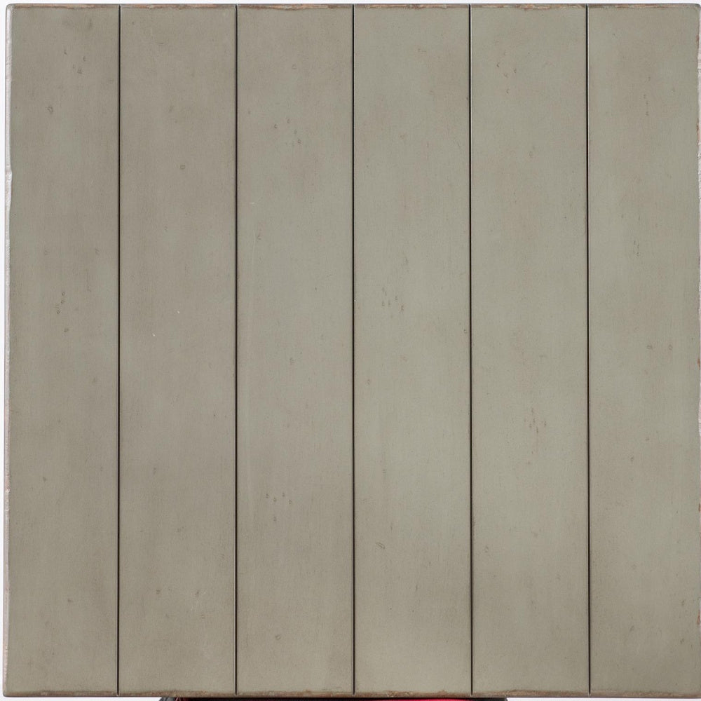 Close-up of a light gray painted wood finish with subtle distressing and plank-style panel details.