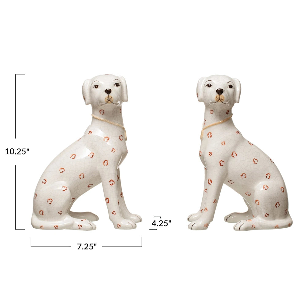 Pair of white hand-painted ceramic dog figurines with crackle finish and orange floral pattern.