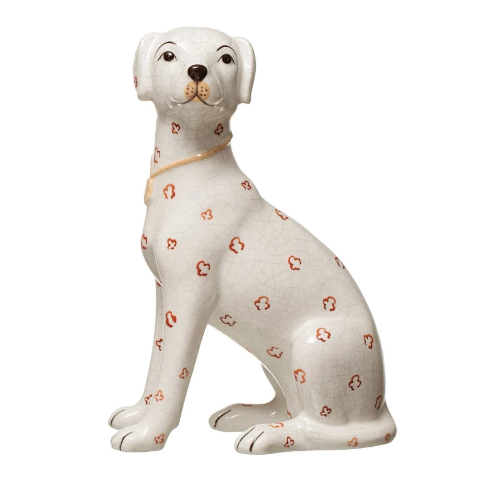 White hand-painted ceramic dog figurine with orange floral pattern and crackle glaze finish. Side view.