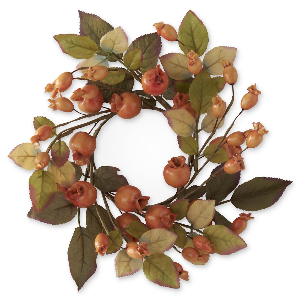 Decorative candle ring featuring muted peach rose hips and olive green leaves on a twig base.