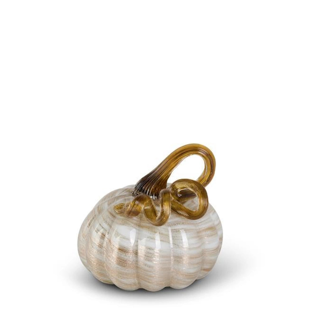 Handblown glass pumpkin with cream and gold swirls and a curly amber stem on a white background.