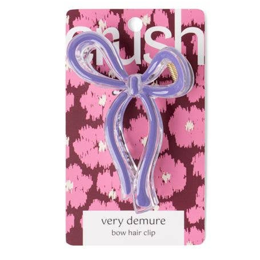 Purple acrylic bow hair clip on pink leopard print packaging, labeled "very demure bow hair clip."