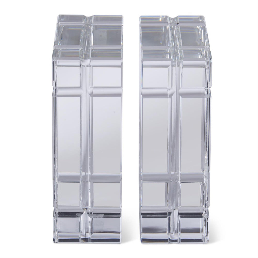 Pair of clear crystal glass bookends with etched grid pane design and geometric beveled edges on white background.