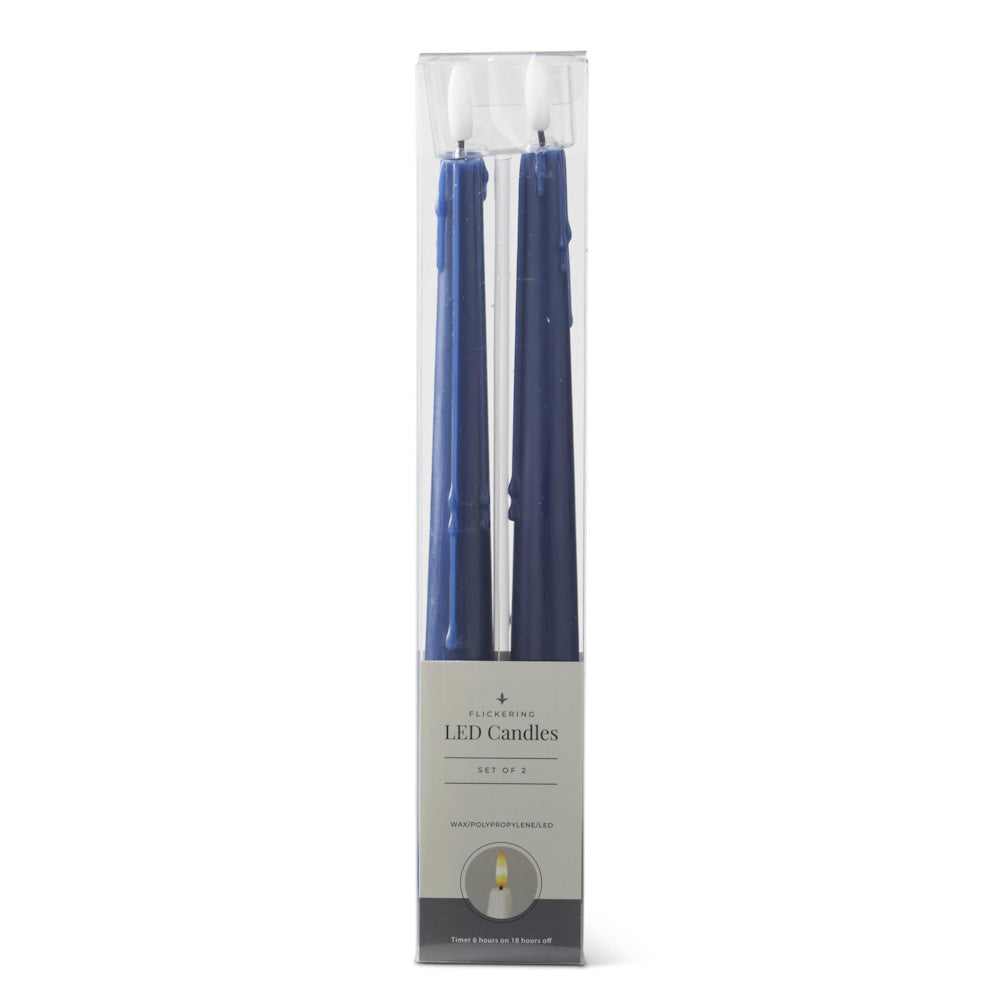 Set of 2 dark blue flickering LED taper candles packaged in a clear plastic box against a white background.