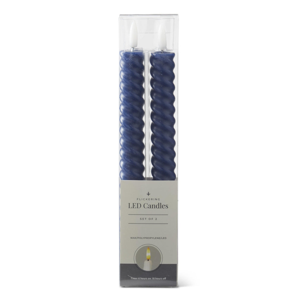 A set of two dark blue spiral LED taper candles packaged in a clear, labeled box.
